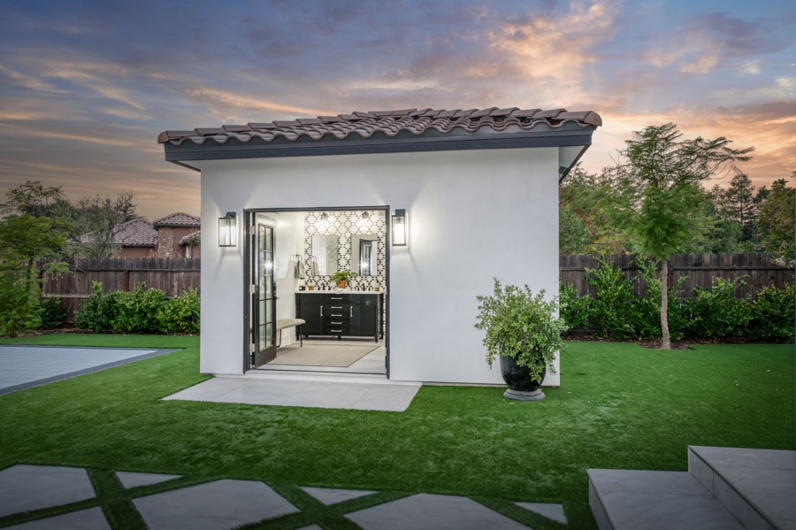14x12 outdoor bath house with double doors open to double vanity at sunset