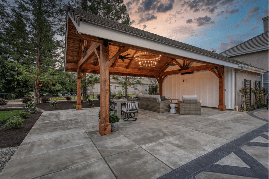 17x23 timber frame pavilion and patio with lighting on at night
