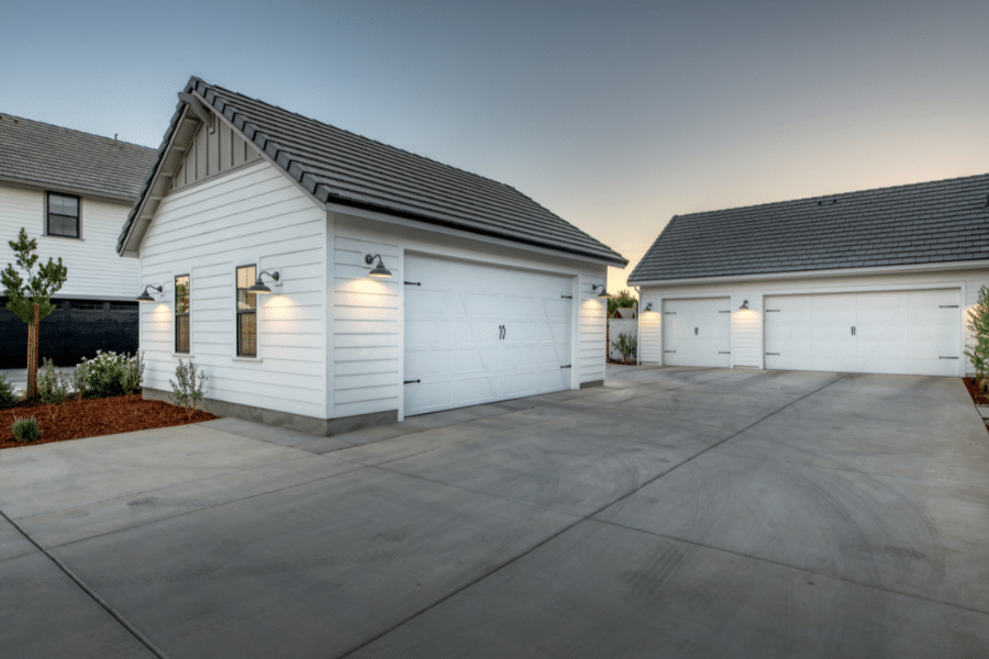 20x24 2-car garage with white siding and black metal roof