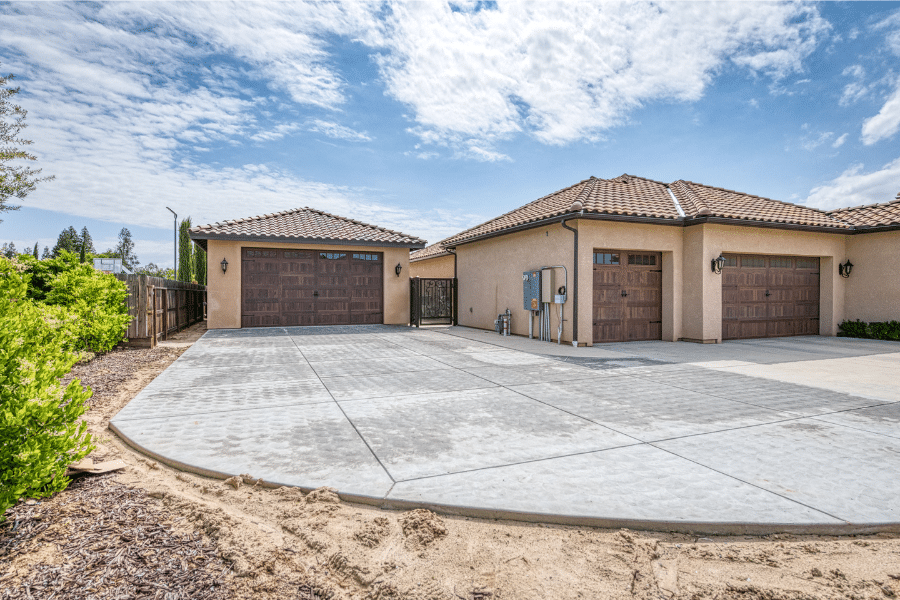 22x34 Garage with stucco siding and spanish title roof with brown garage doors perfectly matching existing attached garage