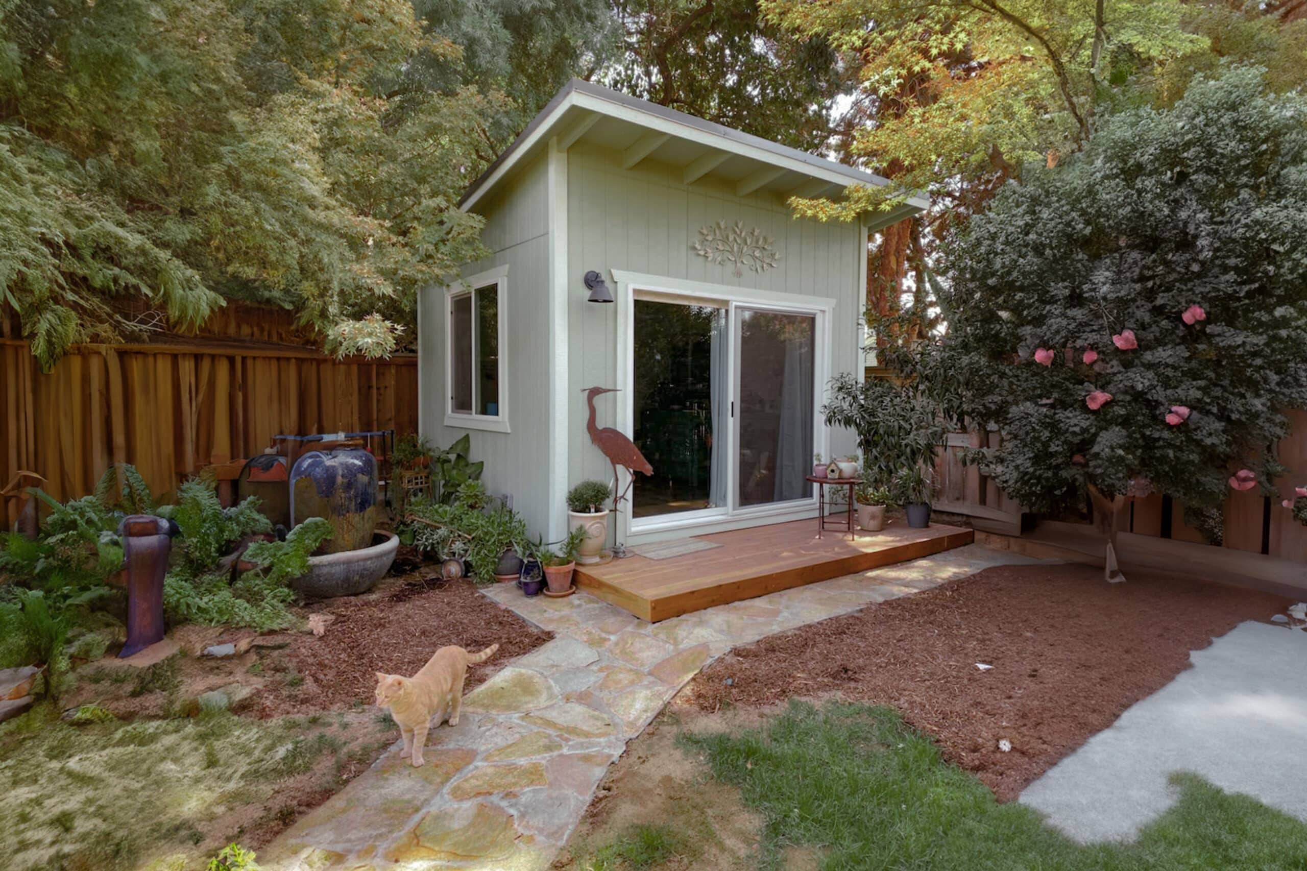 Green lean-to shed in backyard