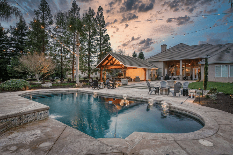 backyard in Clovis, CA featuring 17x23 timber frame pavilion, concrete patio, and pool