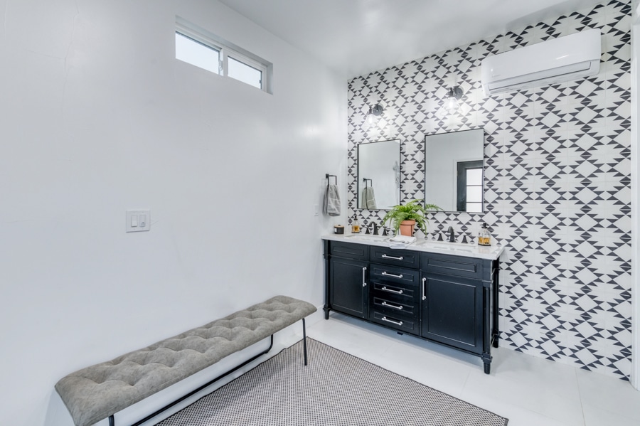 bench and double vanity inside 14x12 outdoor bath house