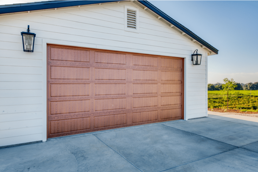 brown garage door and lights on either side on 24x30 2-car garage
