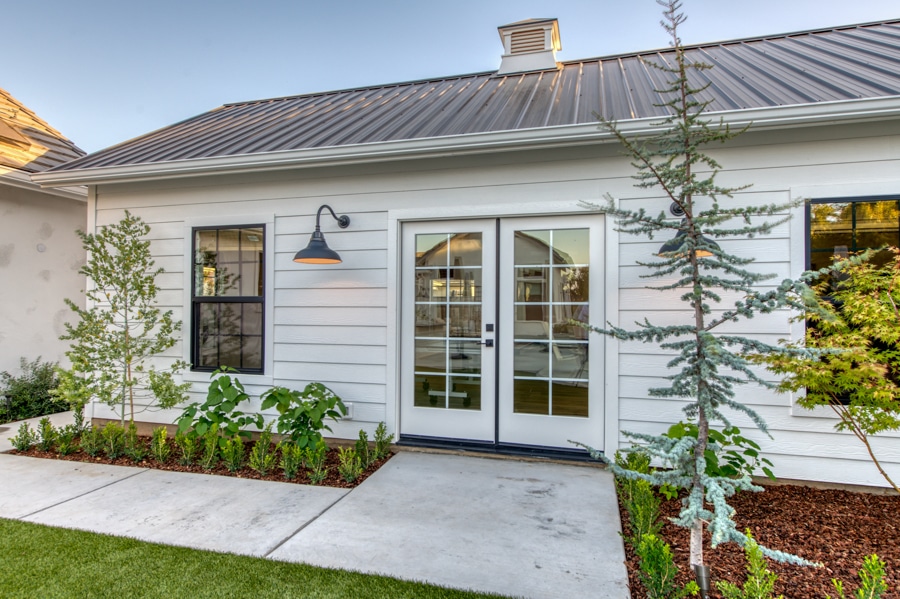 close up of white 16x30 pool house and game room with French double doors