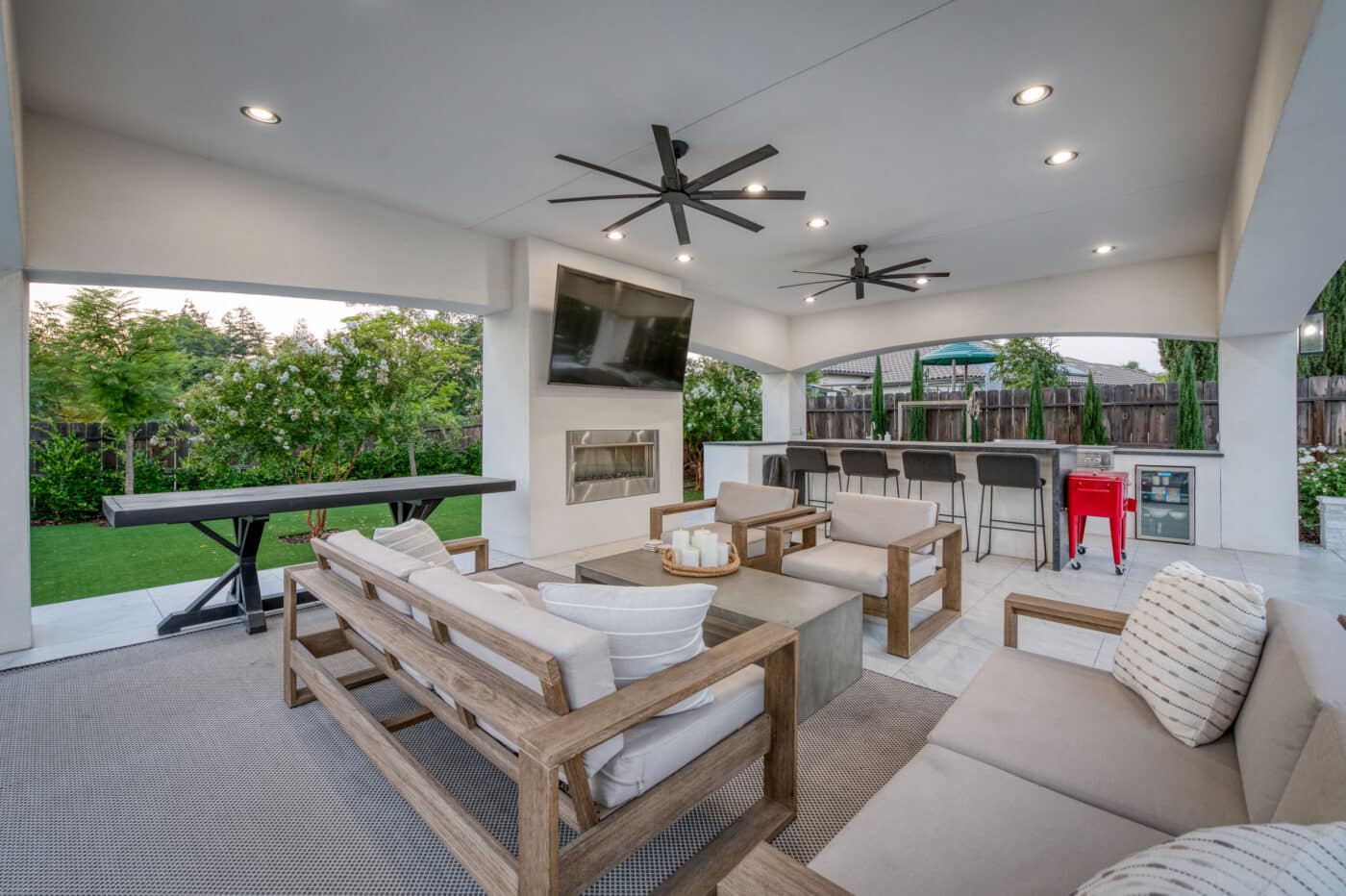 comfortable seating options underneath custom pavilion with fans and lighting on top