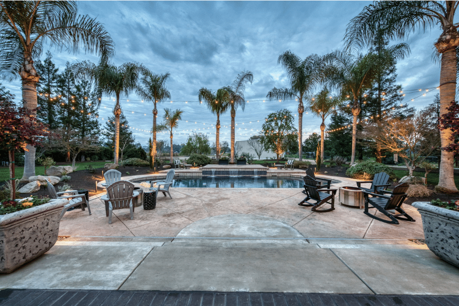 concrete patio and fire pits around pool in Clovis, CA