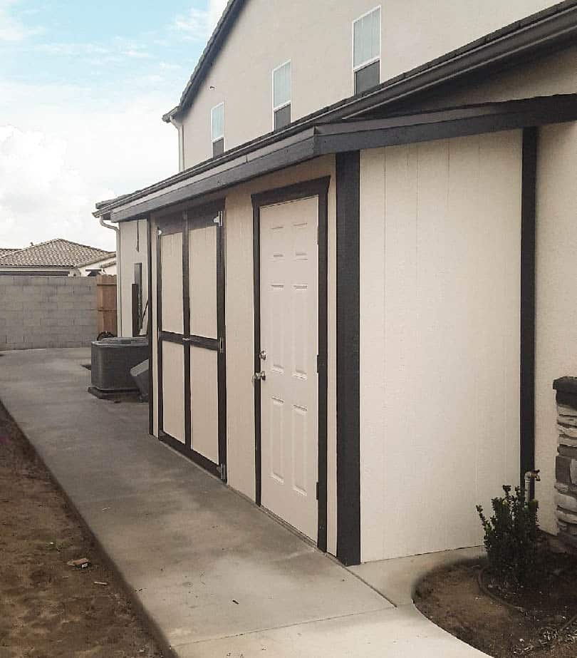cream and black trimmed lean to value sheds in Clovis CA attached to side of home