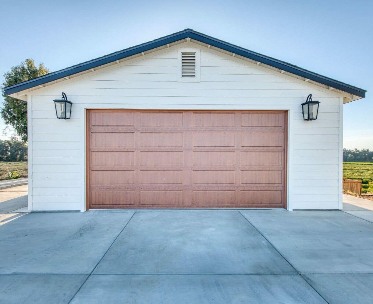cream two car garage with one red garage door