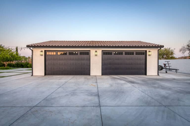 tan custom garage in Fresno CA with two brown garage doors