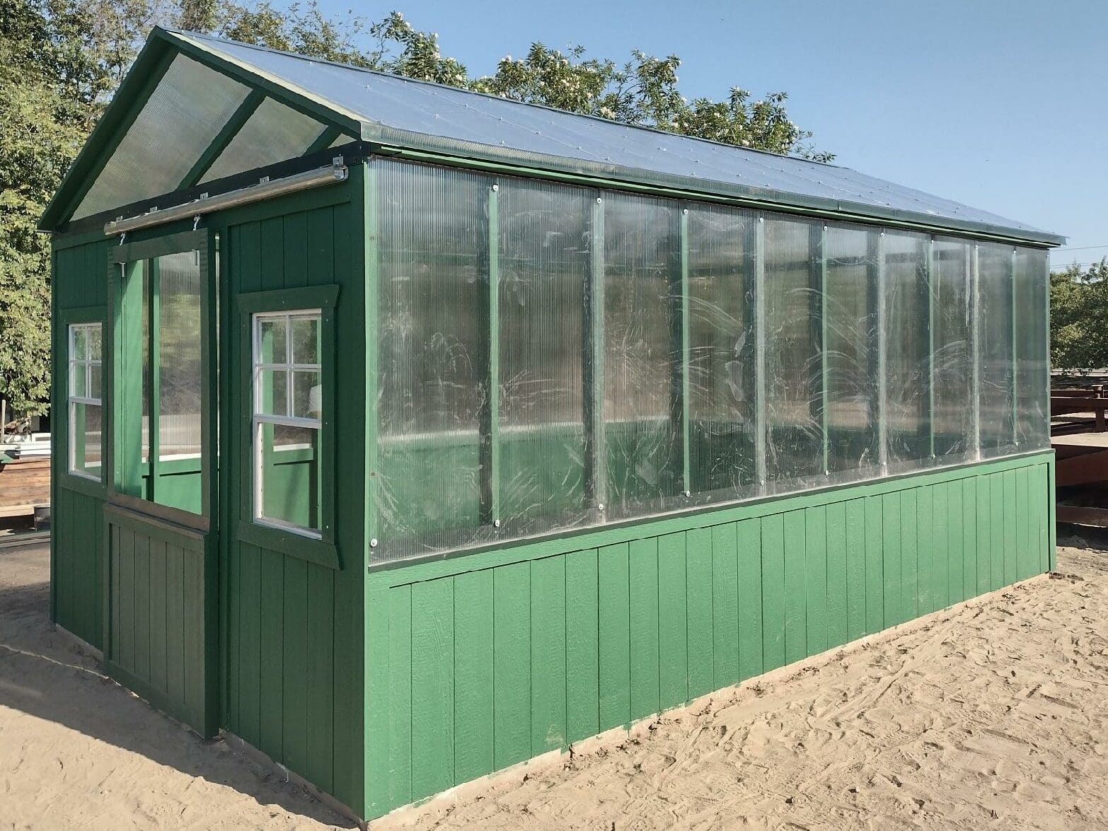 green custom shed with clear siding on upper half in Fresno CA