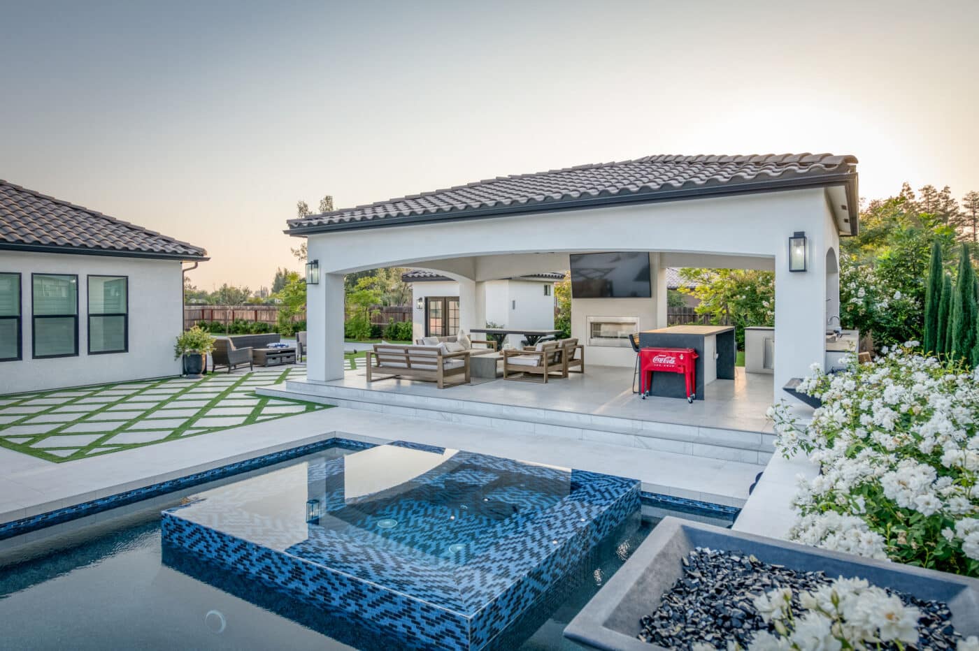 custom pavilion beside pool with seating and kitchen
