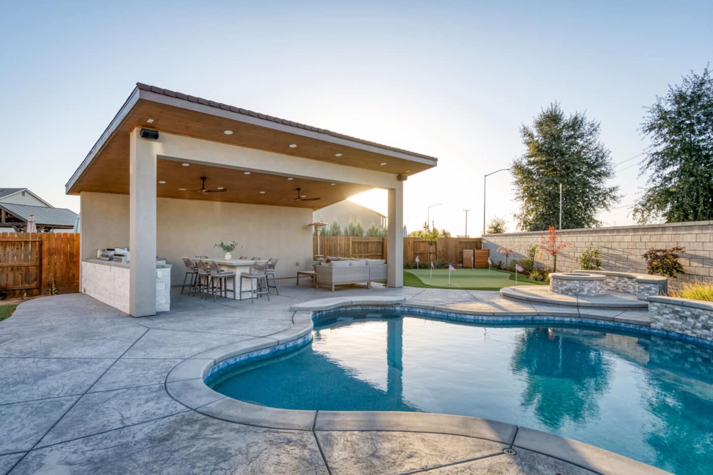 custom poolside pavilion with grill and seating area
