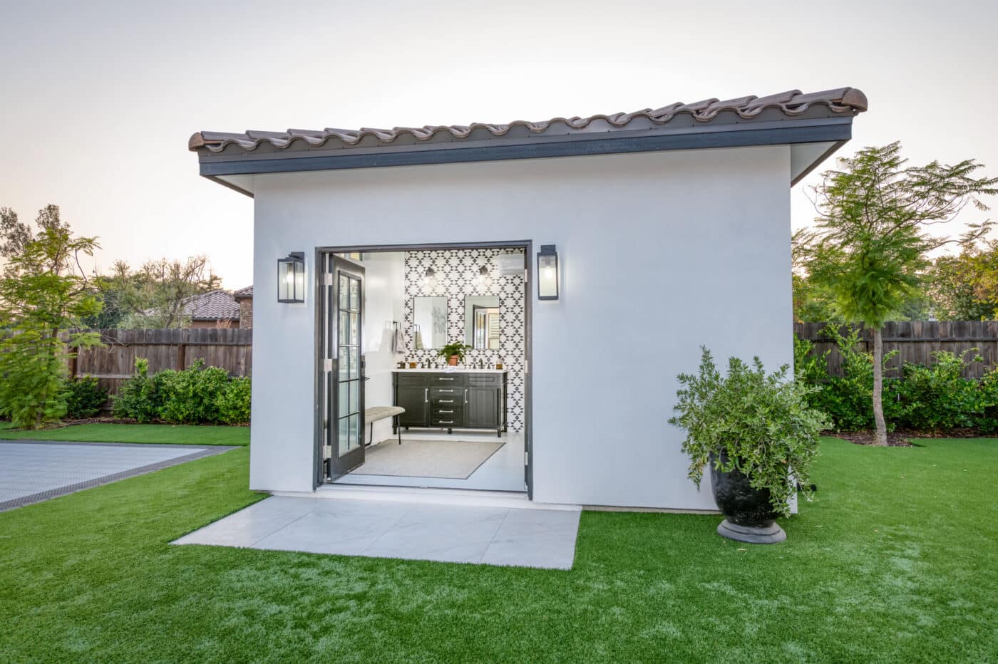 custom white poolside cabana with bathroom and shower inside