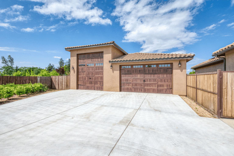 beige three car garages with brown garage doors in friant ca