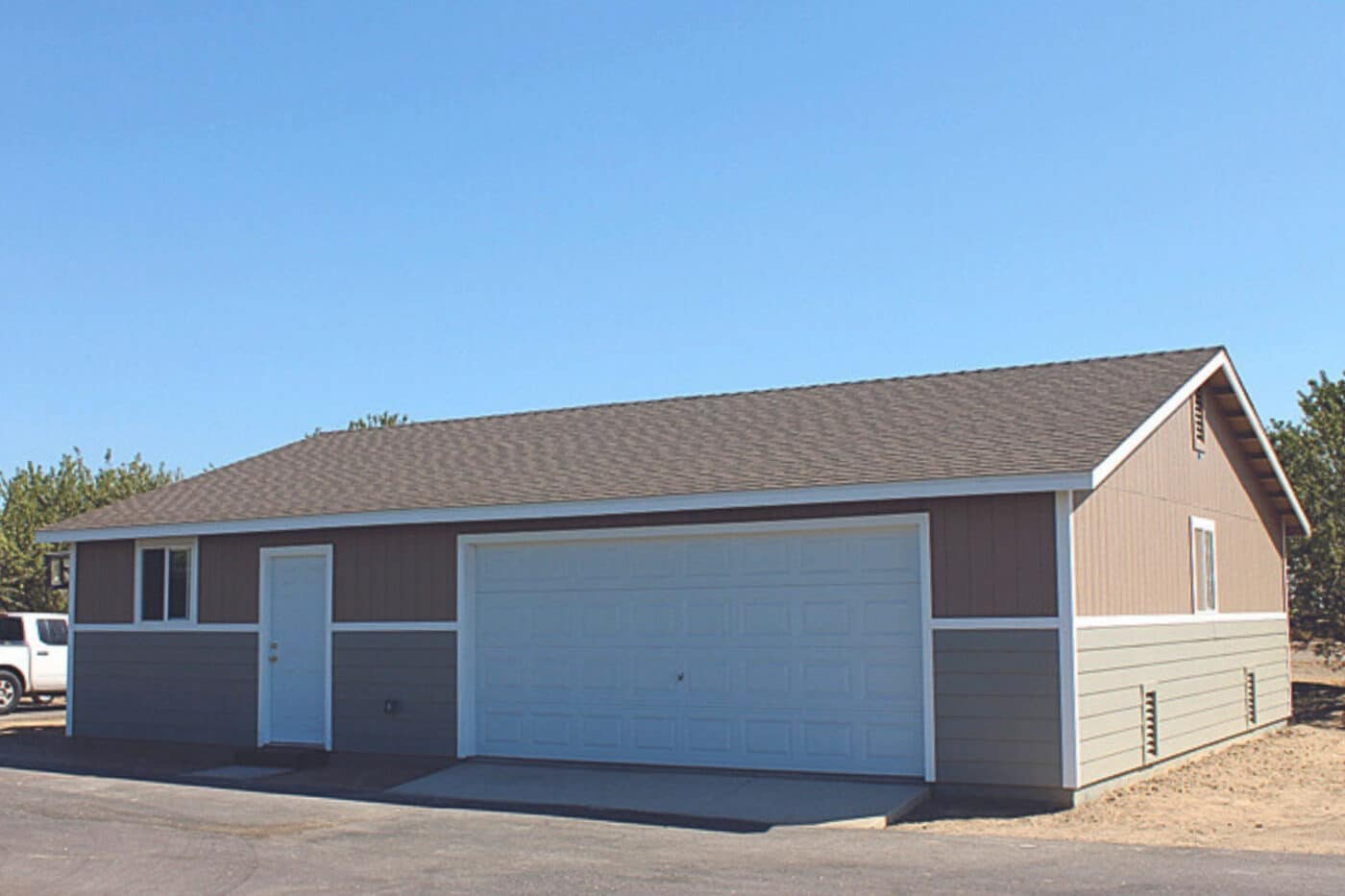 gray and red sided garage with white trim and one white garage door