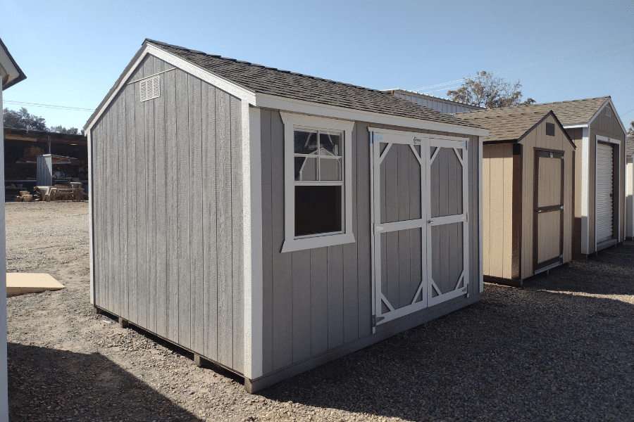 gray and white trimmed deluxe ranch shed in lot