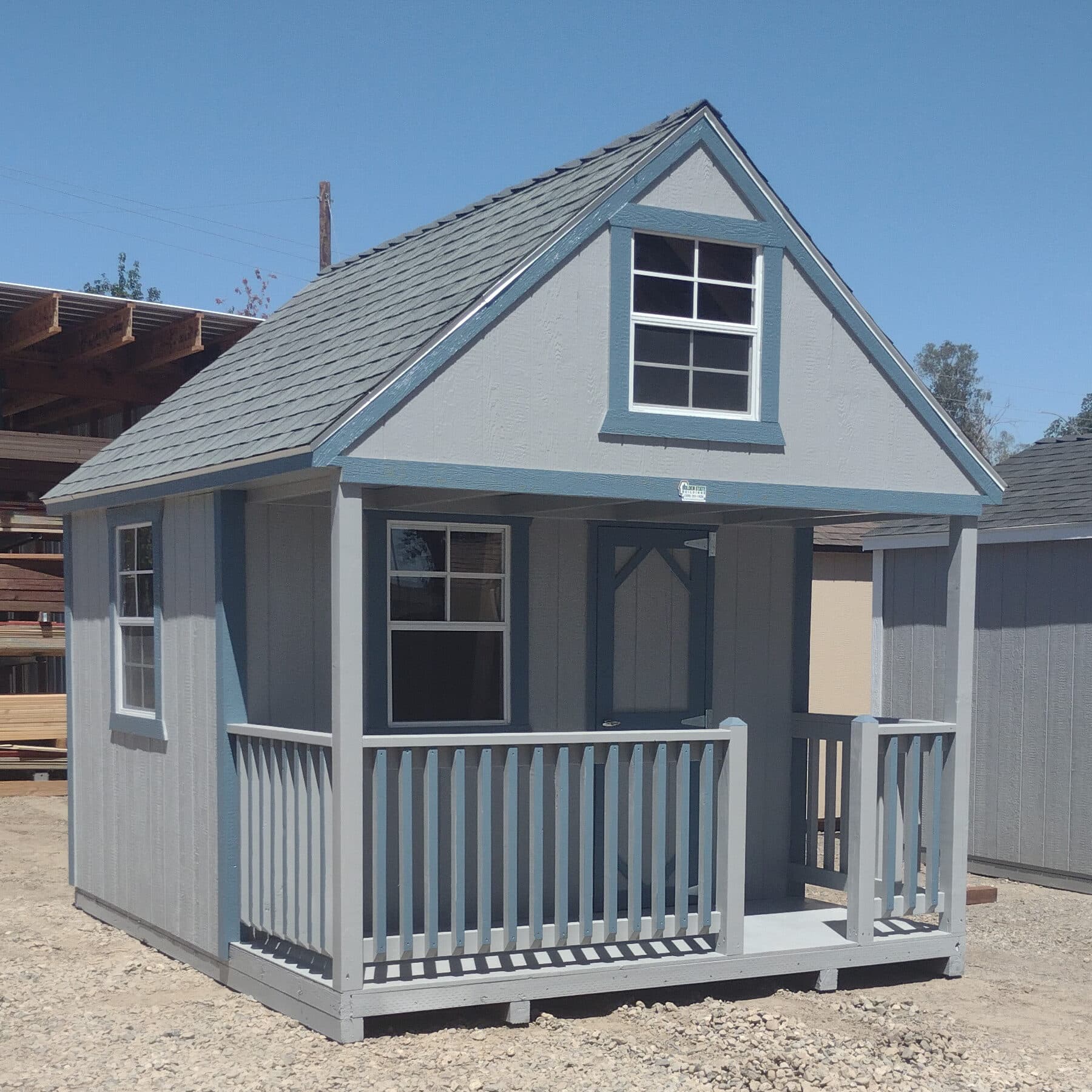 gray clubhouse with blue trim and front porch