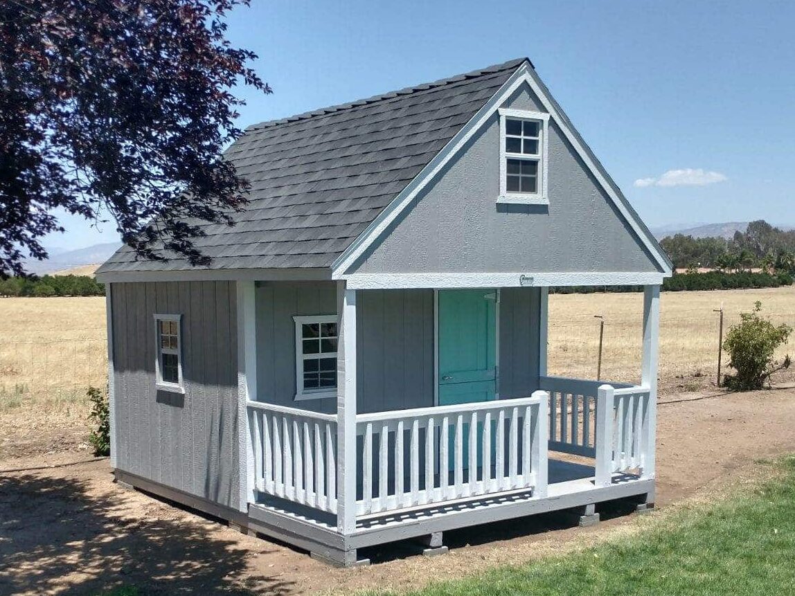 gray clubhouse with blue door and front porch