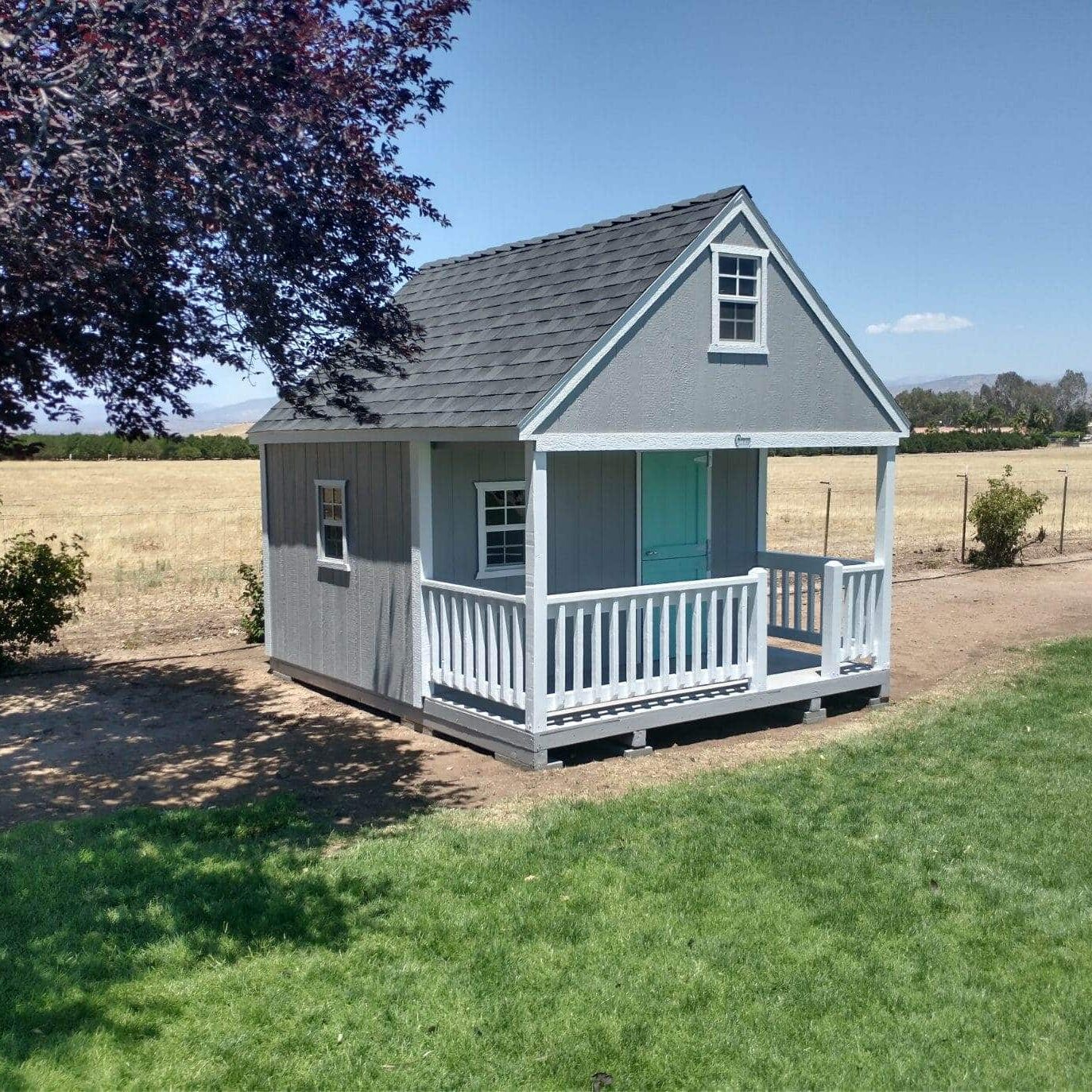 gray kids playhouse white white front porch and blue front door