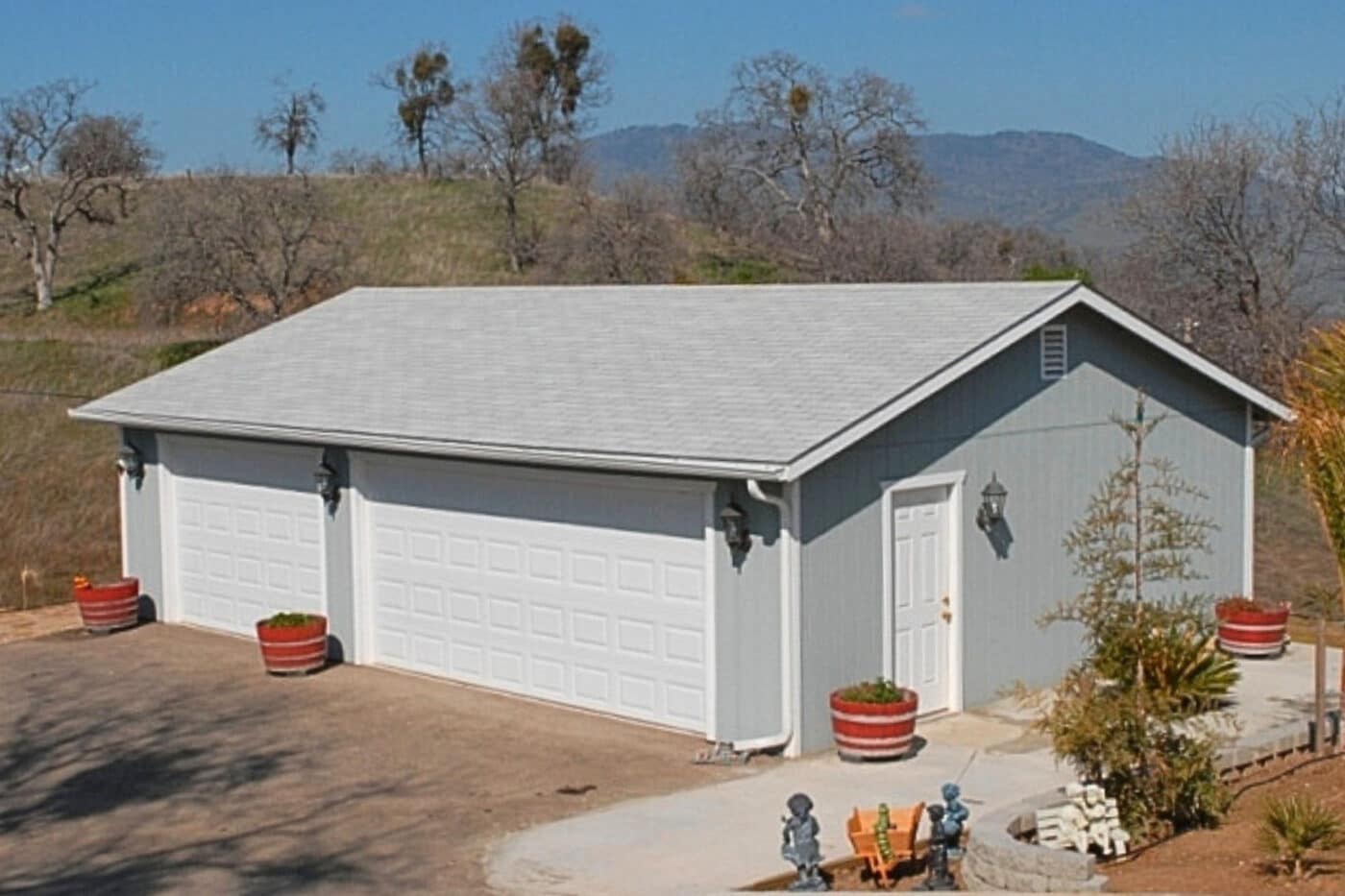 gray three car garages near Madera CA with two white garage doors