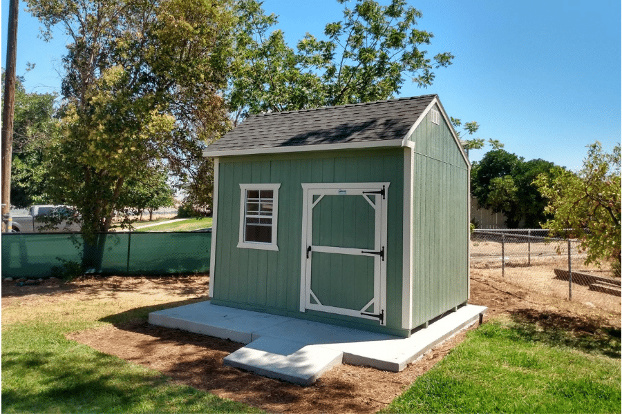 green and white trimmed deluxe garden shed on a concrete pad in Squaw Valley CA