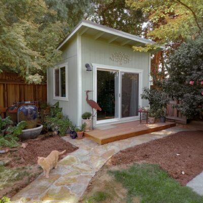 green lean to deluxe shed with front porch