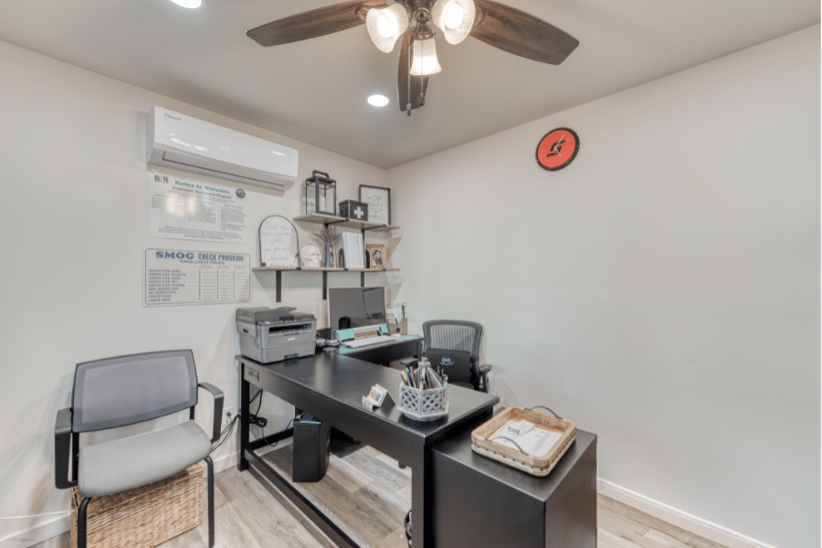 interior of custom office shed featuring desk, Ac_heating unit, and ceiling fan