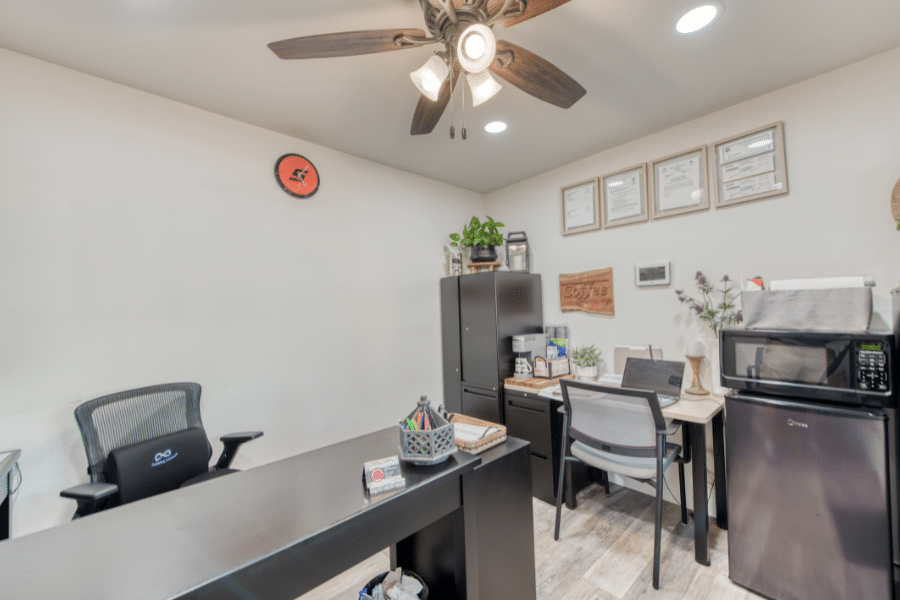 interior of custom office shed with filing cabinets, microwave, and mini fridge