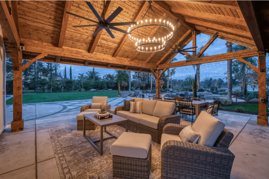 lighting and fan with concealed wires over outdoor seating area underneath timber frame pavilion