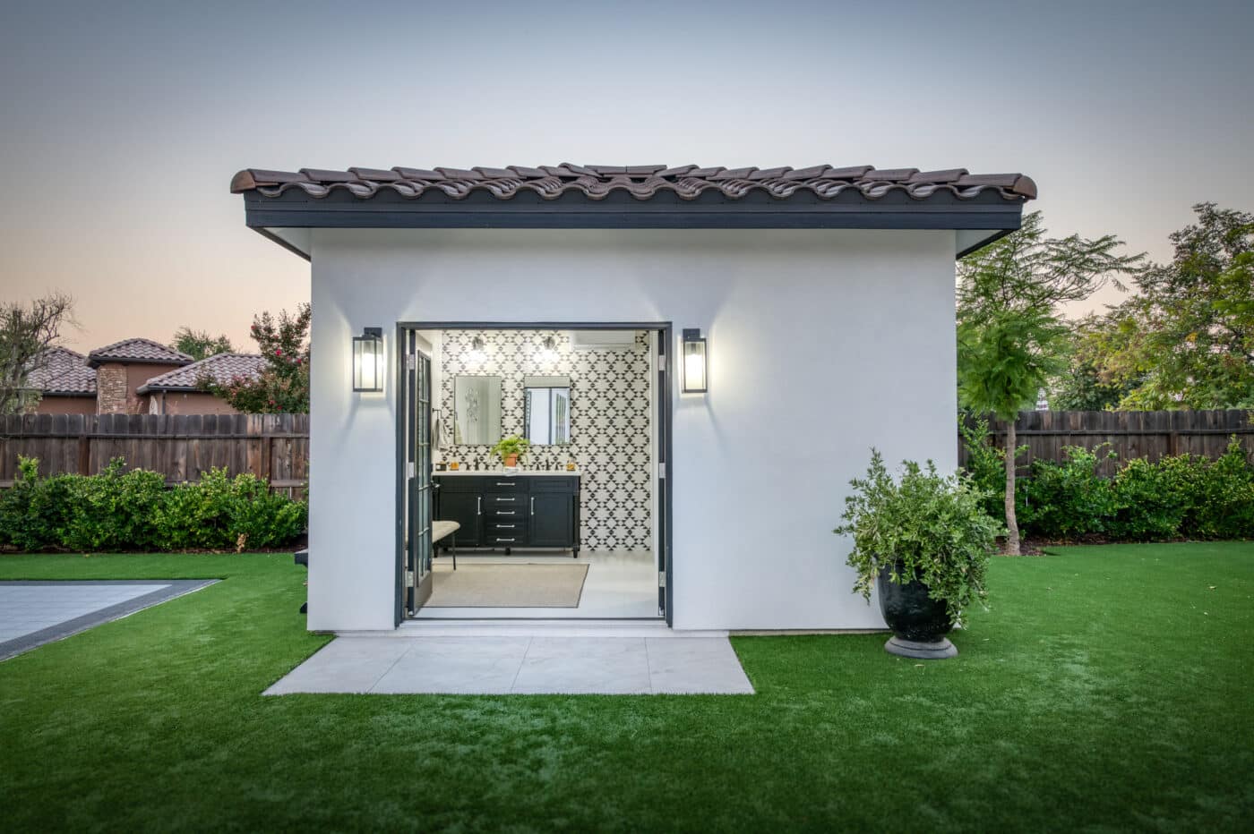 open doors into poolside cabana bathroom and shower house