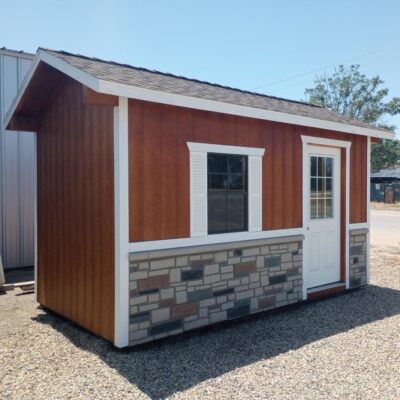 orange sided ranch elite she near Goshen CA with white trim shutters and door and stone detailing at bottom