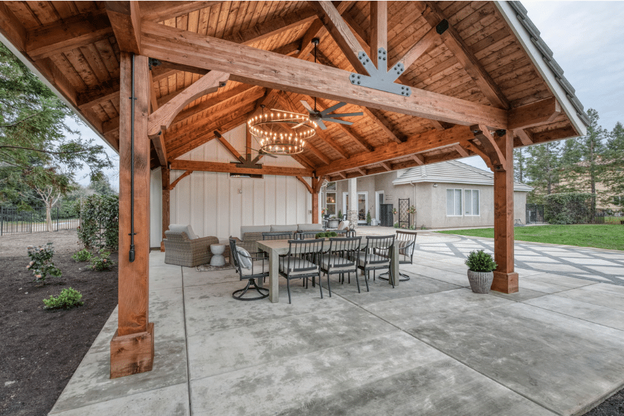 outdoor dining table under 17x23 timber frame pavilion in Clovis, CA