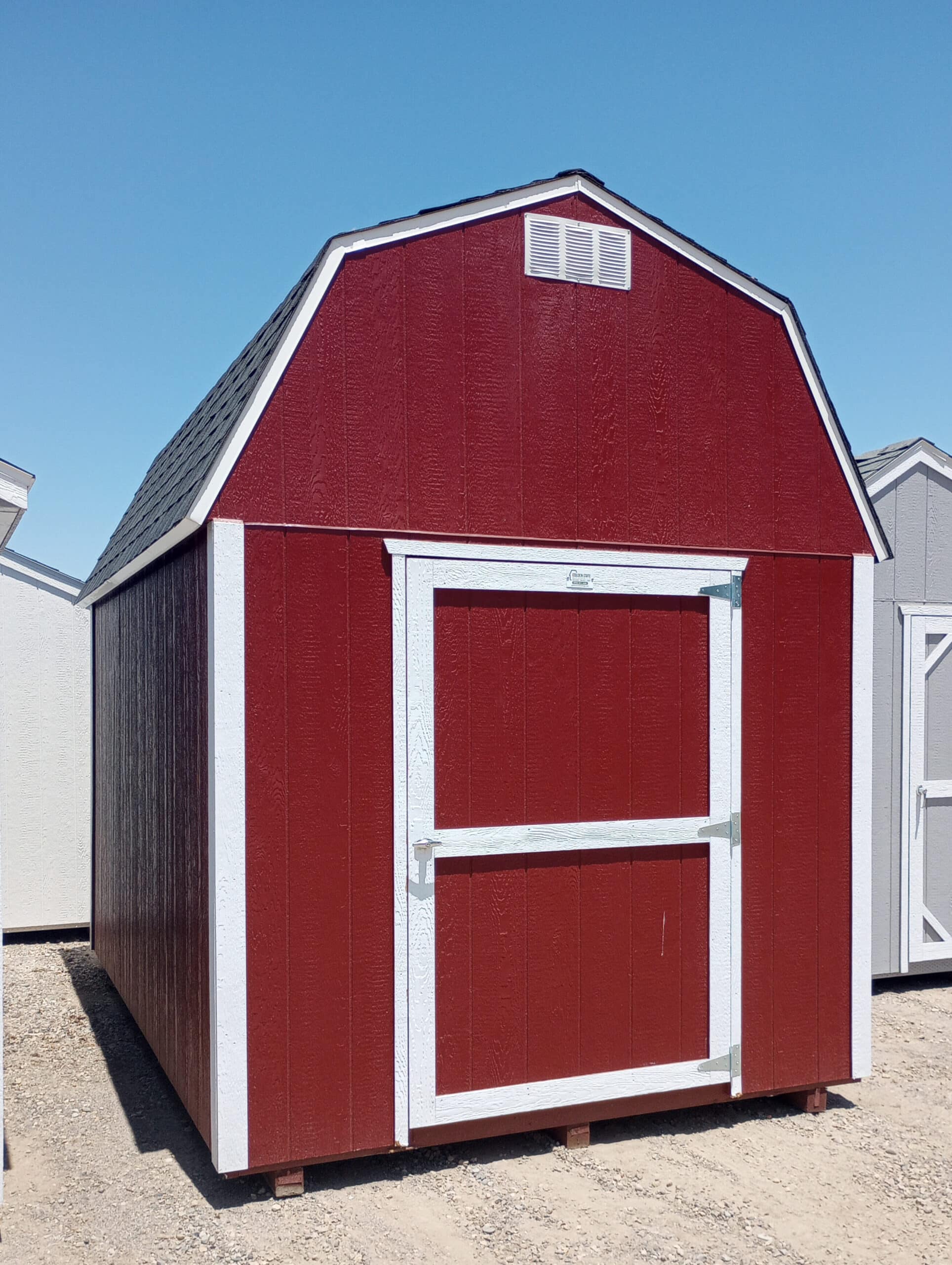 red and white trimmed shed in lot