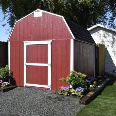 red and white trimmed value stormax with garden bed around it