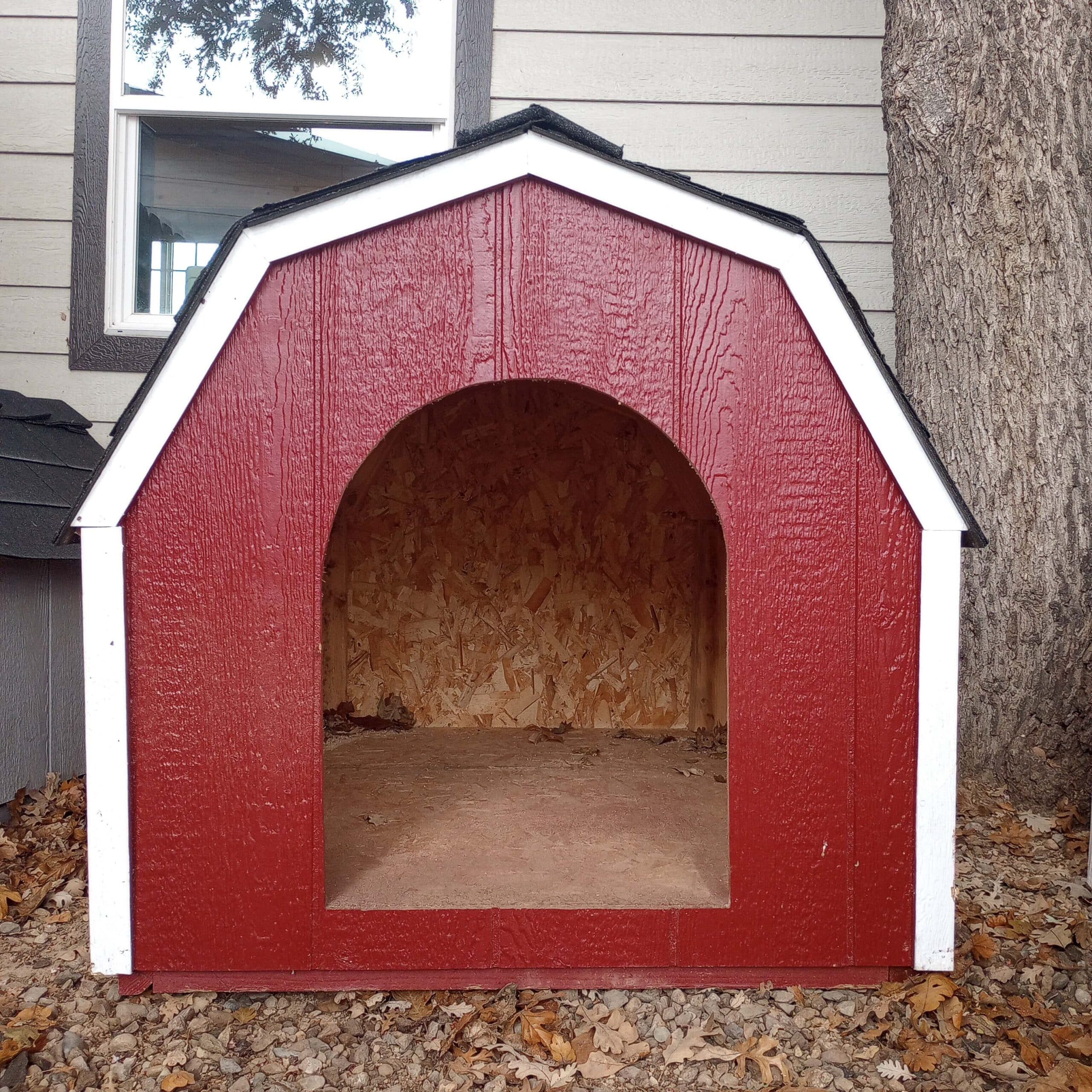 red dog house with white trim and black shingle roof