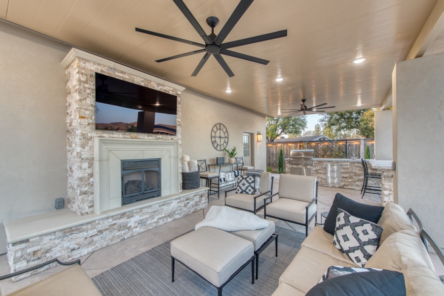 seating area and TV and fireplace on patio beside 30x50 garage