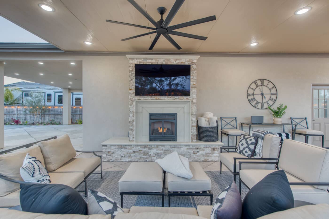seating area with TV and fire put as well as fans and lights