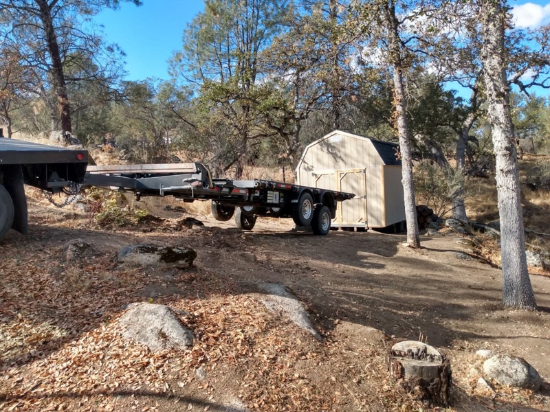 shed being unloaded off truck onto property in California