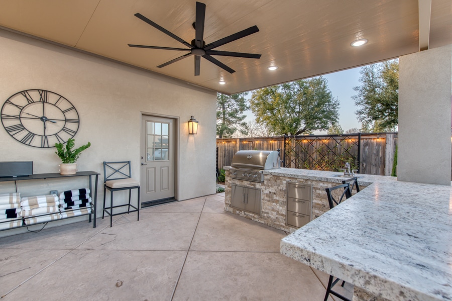 side door to 30x50 garage by attached patio with outdoor kitchen