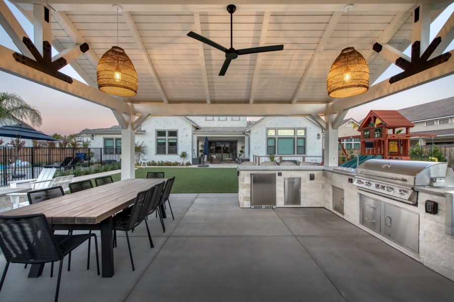 side view of 16x20 Timber Frame Pavilion and Patio with lighting on featuring outdoor kitchen and dining table