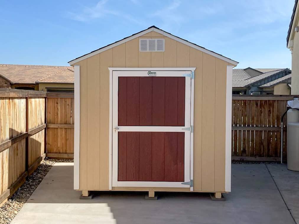 tan and red doored value shed