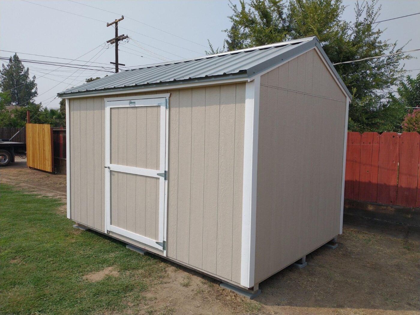 tan deluxe ranch shed with white trim