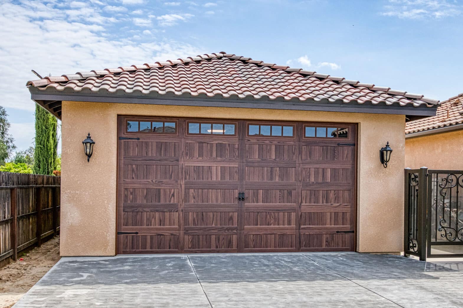 tan garage with brown overhead door with transom windows