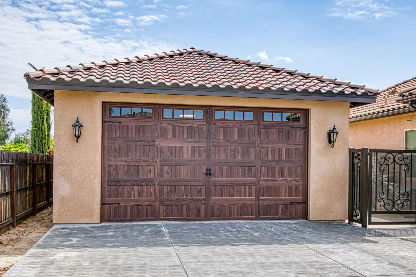 tan garage with brown overhead door with transom windows