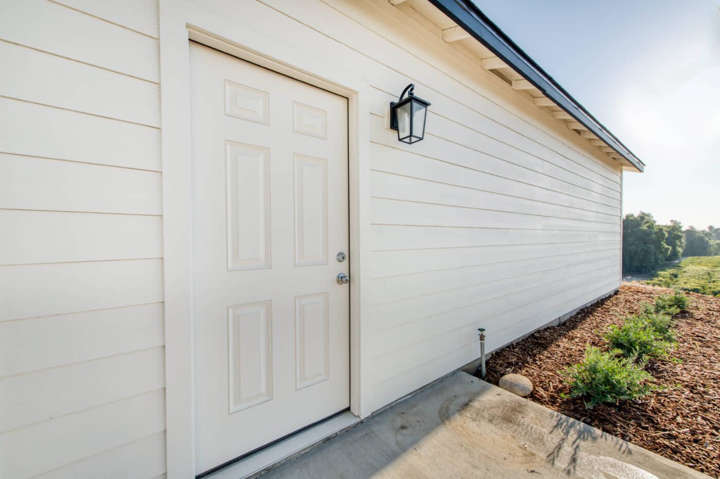 tan siding on garage with tan side door