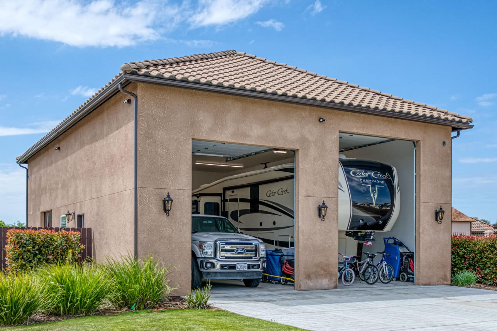 tan two car garage with different sized doors large enough to fit truck and camper