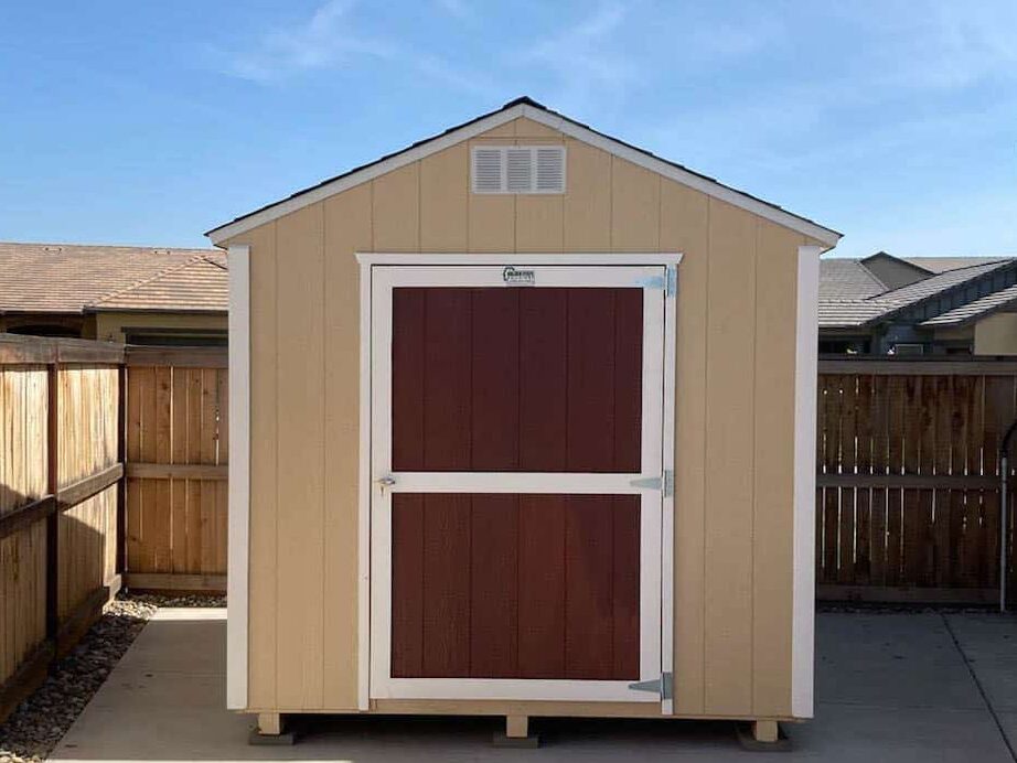 tan value rancher shed with red doors and whtie trim