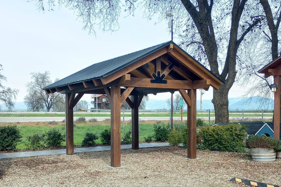 timber frame pavilion in much with black metal roof in Visalia CA