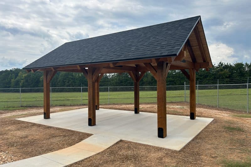 timber frame pavilion over concrete pad creating shaded area